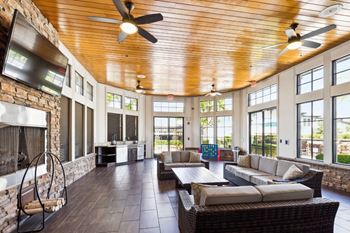 a large living room with couches and a fireplace at The Loree, Jacksonville, 32256